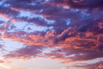 Dramatic fiery sunset sky in a mixture of violet, pink, orange and black colors