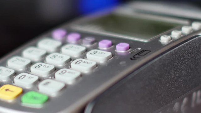 Customer paying with NFC technology by mobile phone on terminal. 4K UltraHD video