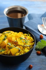 Batata Poha / Indian breakfast with potatoes and flattened rice, selective focus