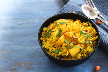 Batata Poha / Indian breakfast with potatoes and flattened rice, selective focus