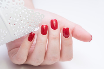 Attractive manicure on women's hands. Natural finger nails with stylish nail art.