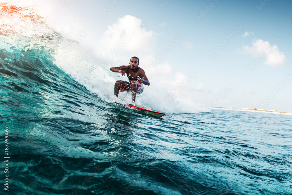 Sticker Young surfer rides the wave. Extreme sport and active lifestyle concept