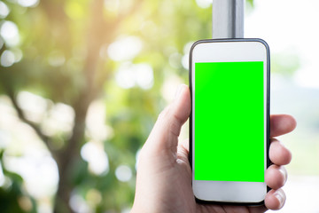 Mockup image of man hand holding white smart phone with blank screen on nature backgrounds