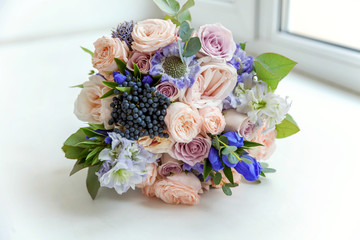 close up of gentle bouquet of the bride in pastel colors with pink roses