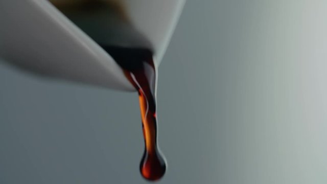extreme close-up liquid soybean pouring from a decanter, adding to a dish, spice in Asian food