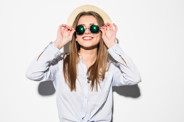 Beautiful cheerful young woman in summer clothes and summer hat over a white background