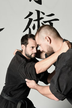 Two men in fighting position of Judo and Ju-jitsu, martial arts