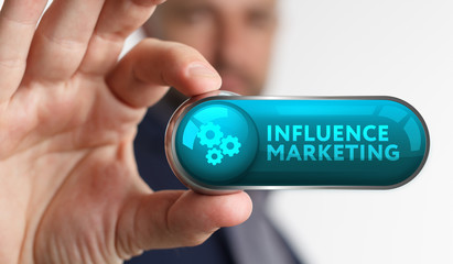 The concept of business, technology, the Internet and the network. A young entrepreneur working on a virtual screen of the future and sees the inscription: Influence marketing