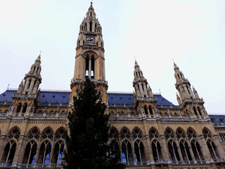 Fototapeta premium Vienna, Austria - December 16, 2017: Tall gothic building of Vienna city hall (Rathaus)