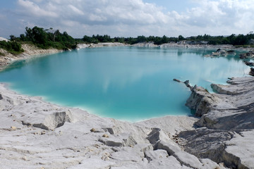 The abandoned salt mines leaves beautiful landscape with blue lake and white shiny rocks
