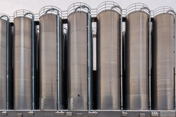 Industrial buildings. Large liquid silo in metallic colors.