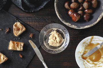 Sweet Chestnut Cream toasts with rosemary honey and anise stars. Rustic wooden background. Selective focus