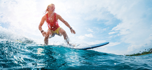 Young surfer rides the ocean wave