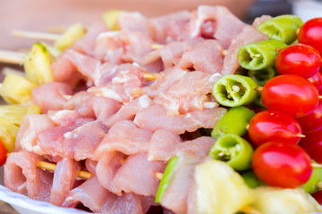 A lot of pork meat was made barbecue with chili pepper, tomato and pineapple for dinner party at backyard