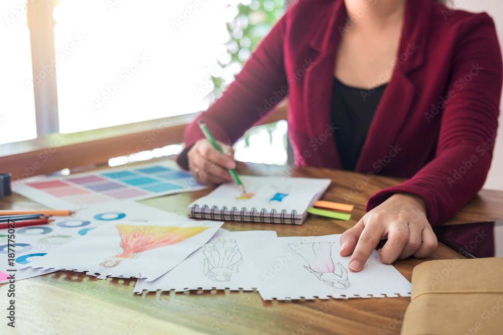 Poster close up of professional fashion designer working and drawing sketches for clothes in workplace and 
