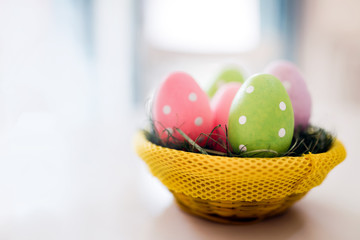 Easter basket filled with colorful eggs