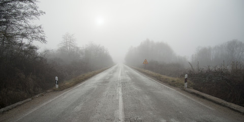 An asphalt road with fog in winter