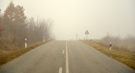 Fototapeta premium An asphalt road with fog in winter
