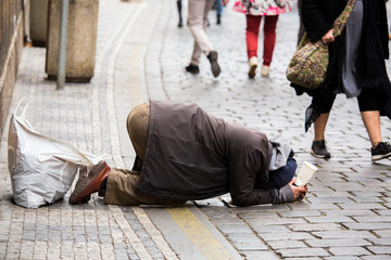 A beggaron the street of a European city