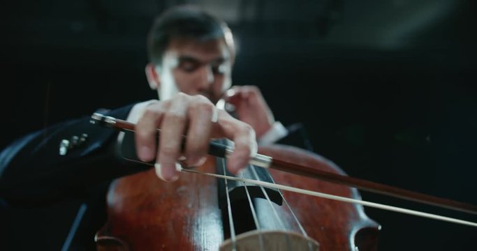 asian cellist male solo classical music performance, close-up