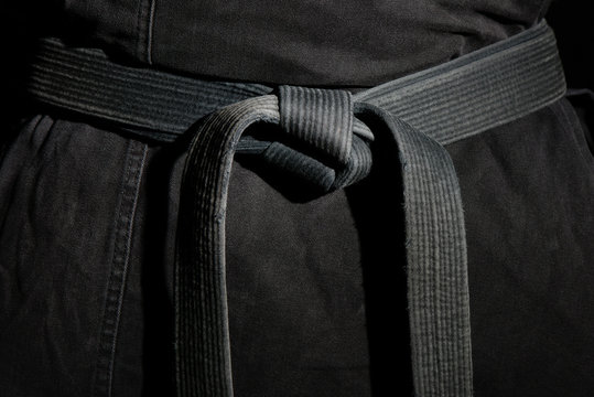 Black judo, ju-jitsu, or karate belt on a black kimono