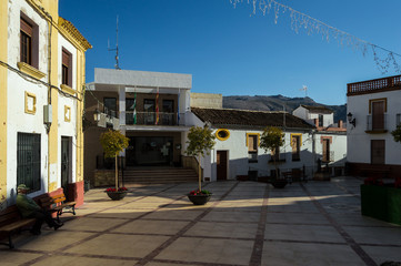 Fototapeta premium Views of the center of the white village of Benaojan with christmas decoration in december. Cute square with the town hall and lovely houses.