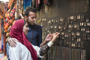 Smiling young muslim couple shopping jewelry