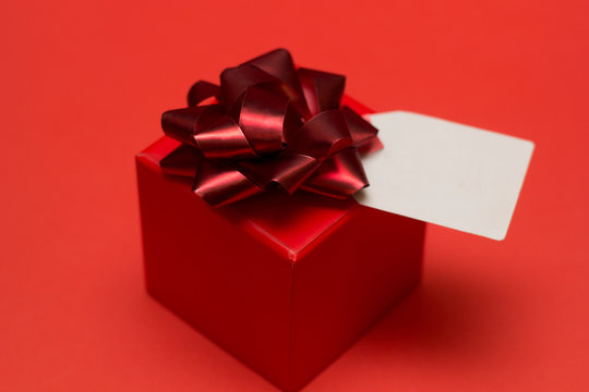 gift box with bow  and white lable on a red background