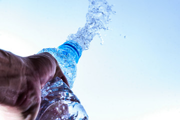 Bottle opening with water splashing isolated on white background.