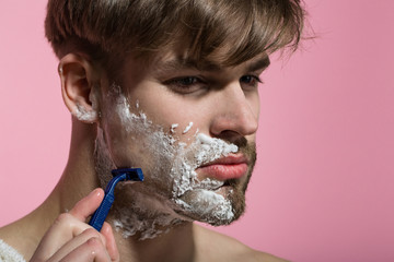 Man shave beard hair with razor on pink background