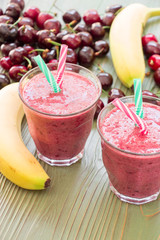 Two glasses of cherries and bananas smoothie.
