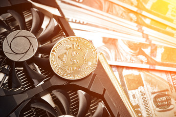 The coin of bitcoin lies on video card with dollars. Exchange bitcoin cash for a dollar. Sun flare