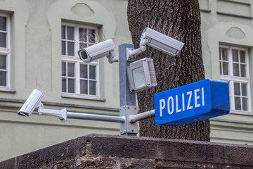CCTV cameras on display next to a police station (with a police sign in German: Polizei) in the Bavarian city of Munich