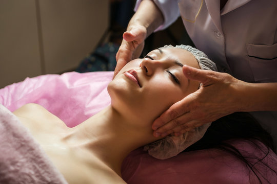 calm girl having spa facial massage in luxurious beauty salon
