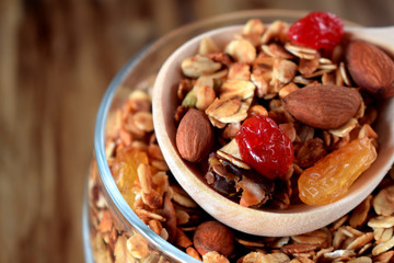 Granola in a glass jar and wooden spoon. Rustic style