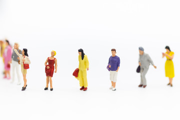 Obraz premium Miniature people: Group of women standing together, used to announce the International Working Women's Day. The definition is: Bread with roses for economic success.