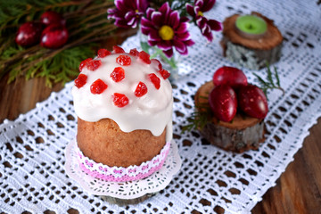 Easter cake on a white cloth surrounded by festive attributes
