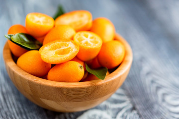 Kumquat or cumquat on wooden table