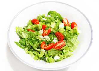 fresh salad with lettuce and tomatoes isolated on white