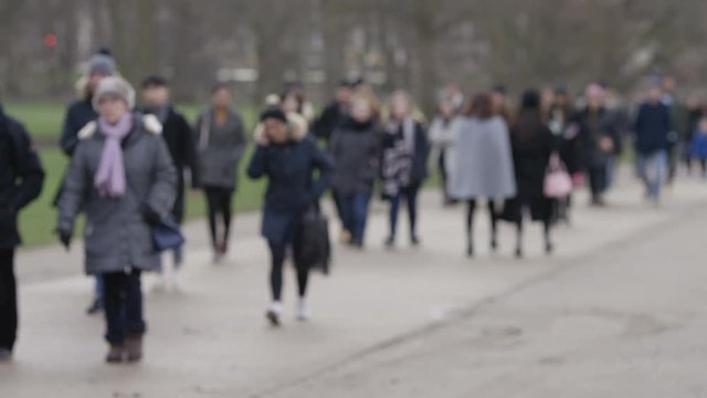 Blurred Shot Of Daily Commuters Taking A Short Cut Through A Park