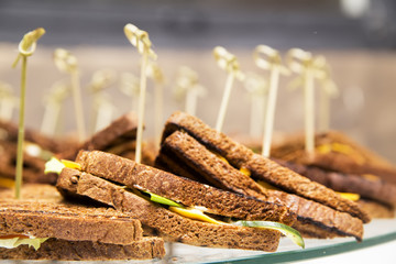 sandwiches in the form of a triangle with cheese and greens