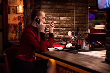 portrait of businesswoman talking on retro phone at bar style 80s