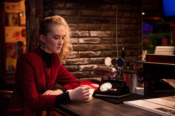 young business woman in 90s style suit burgundy color at bar 