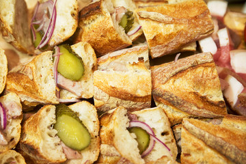Sandwiches with pickled cucumber, ham and onions