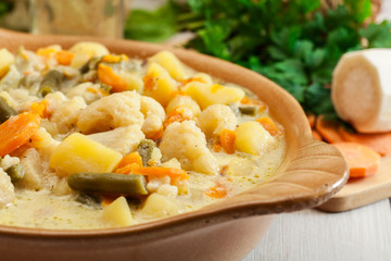 Vegetable soup with ingredients carrot, cauliflower, potato and parsley