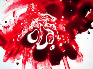 Red viscous fluid smeared on white background, close up