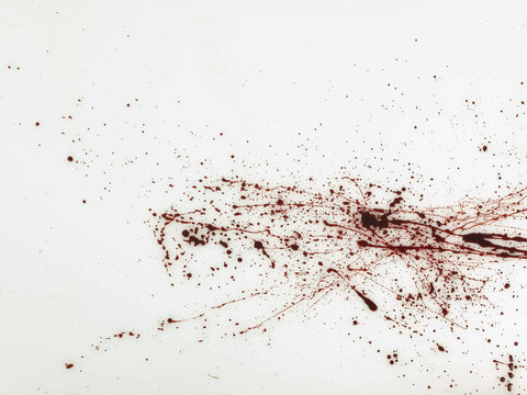 Spatter of red fluid on white background 