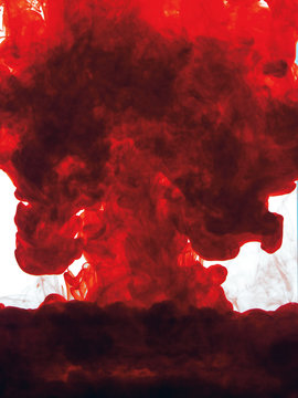 Red colour cloud of pigment in water
