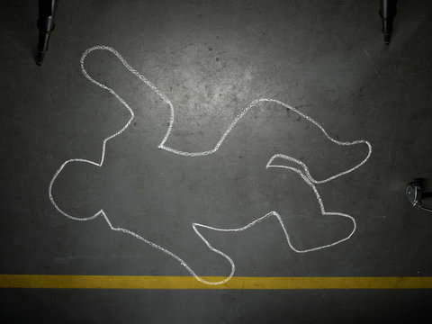 Chalk outline of human body on concrete floor 