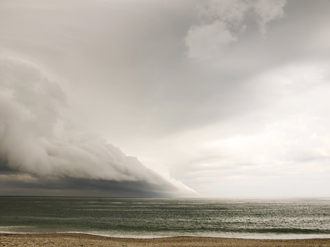 Atmospheric cloud over sea and sandy beah 